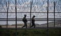 South Korean soldiers patrol near a barbed wire fence along the Demilitarised Zone (DMZ) separating North and South Korea.