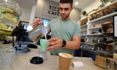 A barista is seen prepairing a coffee at a cafe in Canberra.