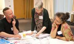 Three teachers discussing ideas over a table of documents at Doing News CPD, Guardian Education Centre and English and Media Centre, 27 June 2019