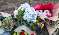 Floral tributes lie next to the road near the site of a bus crash in Cessnock, Hunter Valley