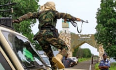 An RSF fighter jumps off a vehicle in a military convoy in Gedaref, Sudan in August.