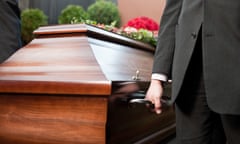 Funeral with casket carried by coffin bearer