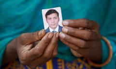 Pawan Kumari holds a photo of her husband, Rajiv Kumar Ray, who died in Kuwait.