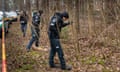 Police officers searching woods