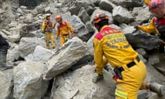 Rescuers work to retrieve the body of a woman under fallen rocks at Jiuqu cave in Taroko National Park in Hualien, Taiwan.