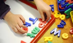 A child plays with plastic letters