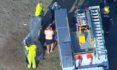 Screenshot from Seven News footage of emergency crews on the scene after a pilot ditched his helicopter into a dam west of Brisbane