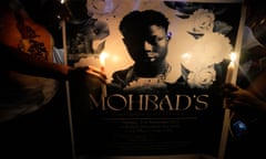 People hold candles during a minute’s silence during a protest at a park in Lagos amid rising anger over the MohBad’s death in unclear circumstances.