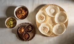 A traditional hopper breakfast, with both plain and egg hoppers, alongside a spread of dal and sambols.