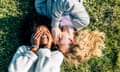 Two best friends telling secrets lying in the grass<br>Posed by models Asturias, Spain, two best friends telling secrets lying in the grass