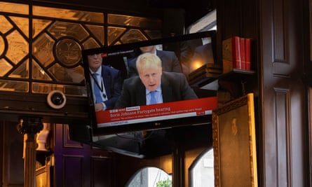 Boris Johnson’s evidence session on Partygate is shown on the TV in a London pub in March 2023