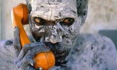 Tom Noytuna uses newly installed Telstra telephone to call clan members to a ritual ceremony at Korlobidahdah in Arnhem Land