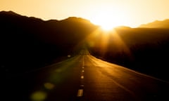 Sunset over a road crossing the Mojave Desert in California, close to the border with Nevada.