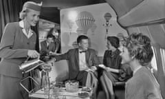 A flight attendant serves cocktails in the lounge of a new Pan American World Airways (Pan Am) Boeing 707, circa 1958.