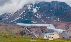 The AltiHut on Mount Kazbek (pictured behind), which straddles the Georgian-Russian border.