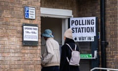 Voters arrive at a polling station.