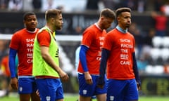 Cardiff players warm up in anti-racism T-shirts before their game against Swansea on Sunday.
