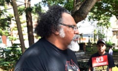 Adrian Burragubba of the Wangan and Jagalingou people (W&J) talks to Queensland's Speaker of the House Peter Wellington before presenting him with a Declaration of Defence of Country outside Parliament House in Brisbane, Thursday, March 26, 2015. The W&J people have announced that they have refused Indian conglomerate Adani and the QLD government a Land Use Agreement for the Carmichael coal mine, the biggest in Australian history, on their traditional lands.  (AAP Image/Dan Peled) NO ARCHIVING