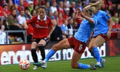 Manchester City’s Steph Houghton tackles Manchester United’s Ona Batlle during the WSL game between the teams in Leigh on 21 May