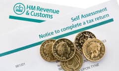 UK HM Revenue & Customs Self Assessment Notice to complete a tax return with some pound coins.