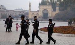 Uighur security personnel patrol near the Id Kah Mosque in Kashgar