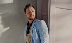 James McAvoy leaning against an open concertina door, wearing pale blue jacket, over a fawn shirt, with shadows