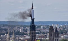 Smoke billows from the spire of  gothic cathedral in Rouen, northern France.