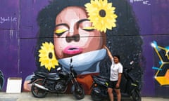 Ana Moreno and her mural, the first to be commissioned from a woman in the once conflict-ridden Comuna 13 suburb.