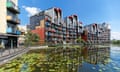 An apartment block next to water in the Millennium Village on the Greenwich Peninsula in London.