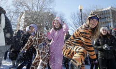 Young ladies wear animal onesie pyjamas during an snowball fight