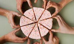 Group of eight people reaching for slice of cake, close-up, overhead view<br>GettyImages-72983838