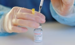 A medic fills a vaccination needle from a vial containing the drug, Spikevax.