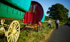 2 colourful caravans with men in background