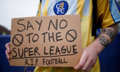 A fan holds up a protest placard in response to the announcement of the European Super League breakaway in 2021