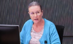 Kathleen Folbigg sitting behind a monitor and a microphone