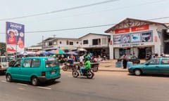 Africa, Liberia, Monrovia. Traffic rushing by busy city market.<br>DEFY53 Africa, Liberia, Monrovia. Traffic rushing by busy city market.