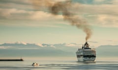 Cruise ship with smoke pouring from its funnel