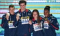 Caeleb Dressel (left) and Simone Manuel (right) pose with Zach Apple (second left) and Mallo Comerford after the mixed 4x100m freestyle relay