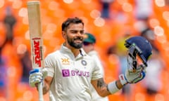 Virat Kohli raises his bat to celebrate his first century for India since a knock of 136 against Bangladesh in 2019. 
