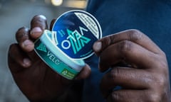 Someone holds a plastic container from British American Tobacco's Velo brand of nicotine in Nakuru, Kenya. 