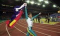 Sprinter Cathy Freeman does a lap of honour, carrying the Australian and Aboriginal flags, after winning gold in the women’s 400-metre final at the 2000 Sydney Olympics.