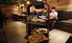 AI serving robot from KT carries foods and drinks during a demonstration at a restaurant in Seoul, South Korea, Tuesday, Sept. 15, 2020. (AP Photo/Lee Jin-man)