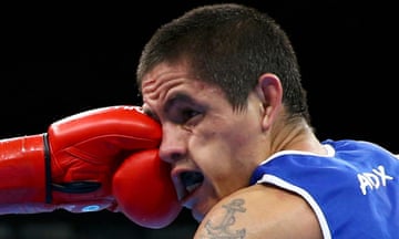 Ignacio Perrin of Argentina takes a blow to the face in the preliminary men’s light boxing (60kg) round of 32.