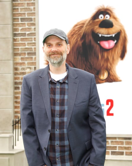 Brian Lynch standing in front of a Secret Life of Pets 2 poster