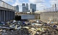 Plastic brought along by high tides litters the high water line in front of Canary Wharf in London, UK. 