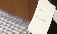 Sticky note with 'Back in five minutes' written on it on computer monitor