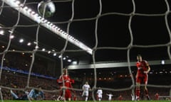 Fernando Torres scores against Real Madrid, with Steven Gerrard watching on, in 2009