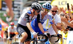 Simon Yates (right) congratulates his twin brother, Adam, at the finish line in Bilbao.