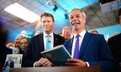 Two men in suits and ties smiling