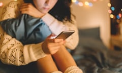 Girl texting on smartphone at home